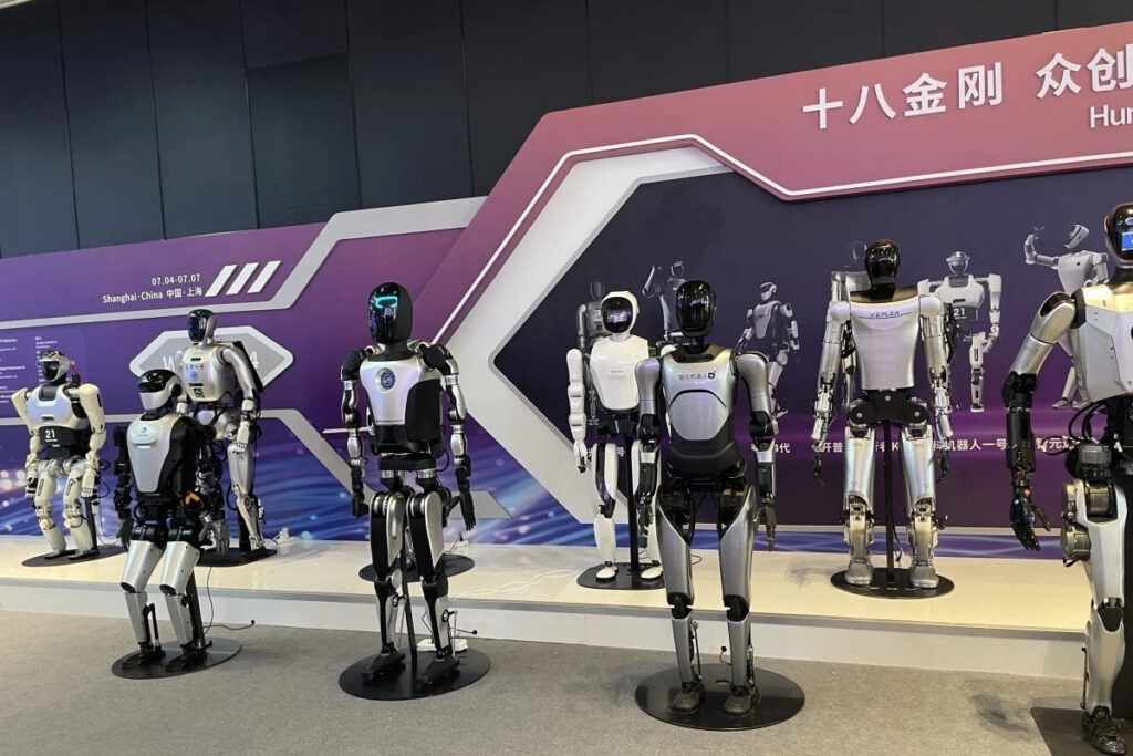 Tesla's Humanoid Robot Optimus Makes Appearance at China AI Conference, Protected by Glass 